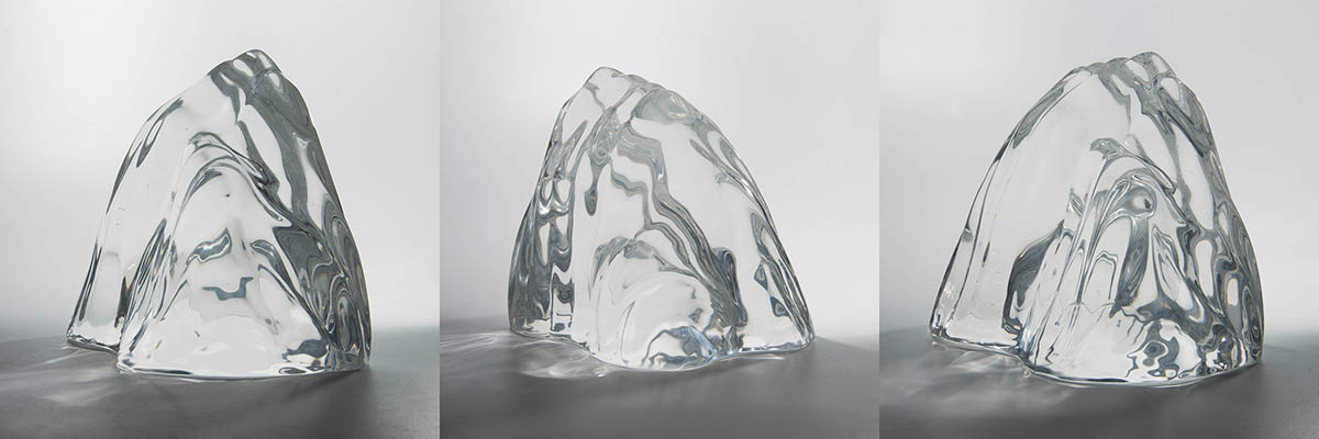 Clear resin sculpture of mountains by Alvin Mak.